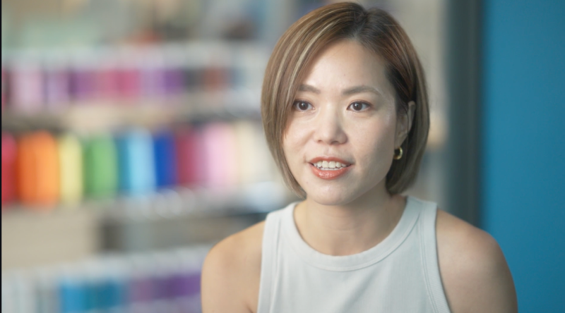 Alice Y speaking toward the camera during an interview