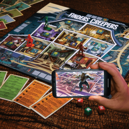 A finders Creepers game board and the view of it through a smartphone, using augmented reality features to enhance the game